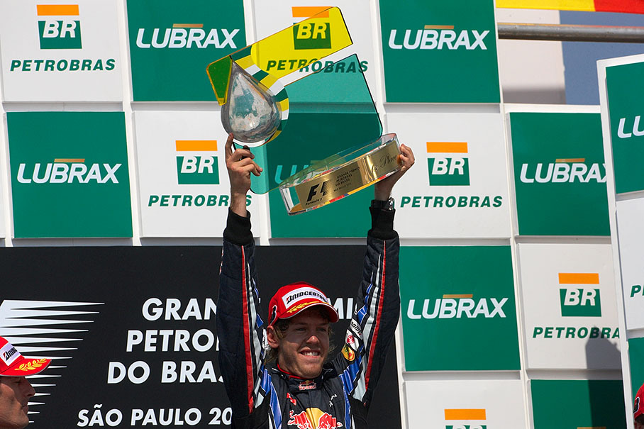 Race winner Sebastian Vettel raises his trophy on the podium