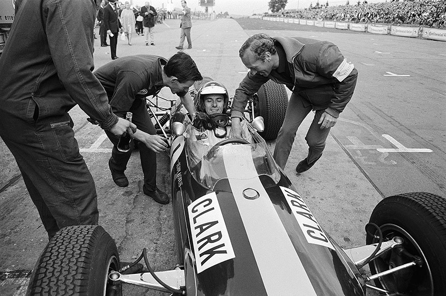 Lotus owner Colin Chapman and chief mechanic Jim Endruweit congratulate Jim Clark for his first and only German GP victory