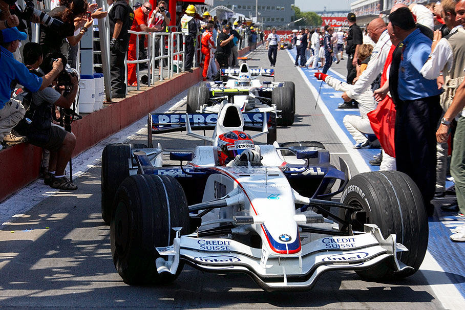 The two BMW Saubers arrive at parc ferme after the successful race