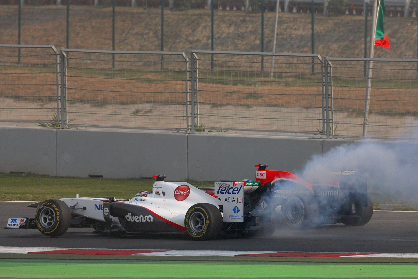 Kobayashi's Sauber-Ferrari has a problem after a spin and touch at turn one after the start