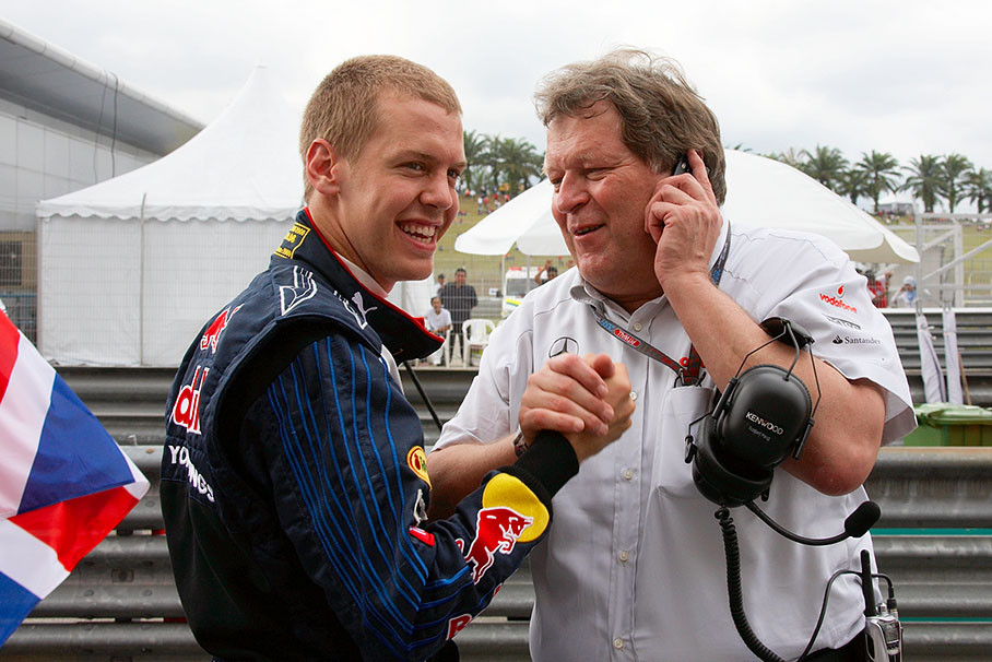 Continuous communicating Mercedes Motorsport director Norbert Haug shakes hands on the grid with Red Bull's Sebastian Vettel