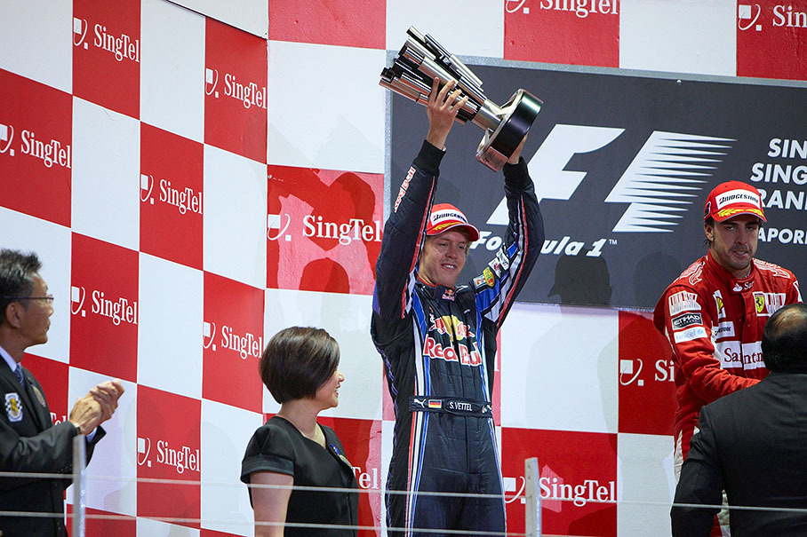 Second placed Sebastian Vettel raises his trophy