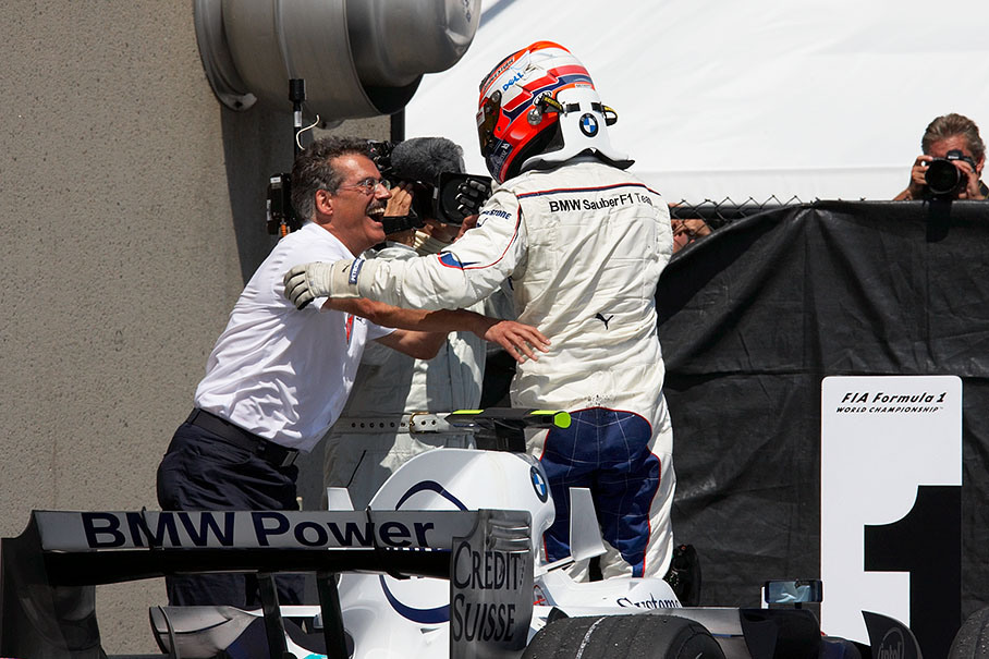 BMW Motorsport director Mario Theissen congratulates winning driver Robert Kubica with overwhelming emotions