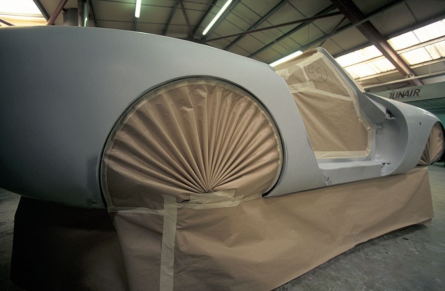 Der Aufbau wird mit vier Schichten Grundierung überzogen. Nach jeder wird er 30 Minuten lang bei 62 Grad gebacken. Anschliessend glättet man ihn, bevor die vom Kunden gewünschte Farbe - eine von 12000 - aufgeprayt wird. Ein Fächer aus braunem Papier schützt die Aufhängungsteile dahinter.