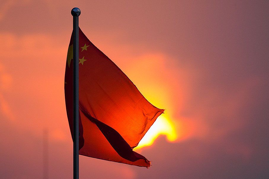 The Chinese national flag flares up in the evening sunlight