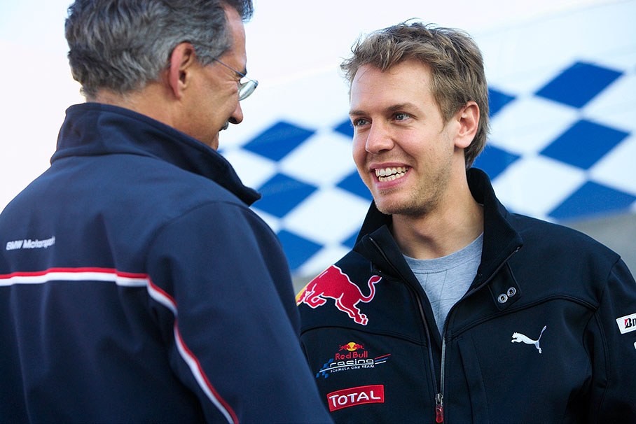 Former BMW comrades Sebastian Vettel and Dr. Mario Theissen chat during a Formula BMW barbecue