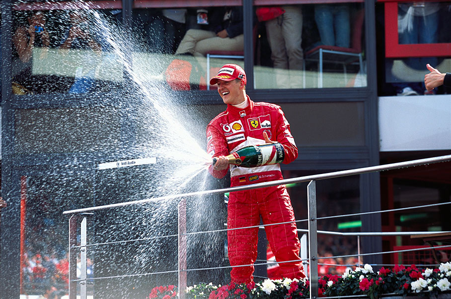 Michael Schumacher giving champagne shower, now 7 times world champion.