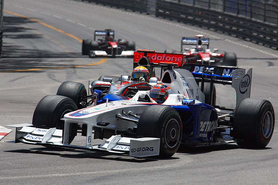 In the course of the Monaco GP, Robert Kubica fights with the brakes of his BMW Sauber car against Lewis Hamilton's McLaren Mercedes, the two Toyotas mark the back