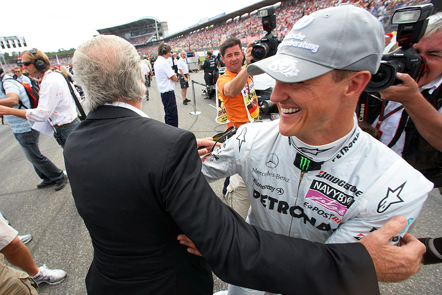 Michael Schumacher, Mercedes GP, is visited by his former manager Willi Weber on the grid