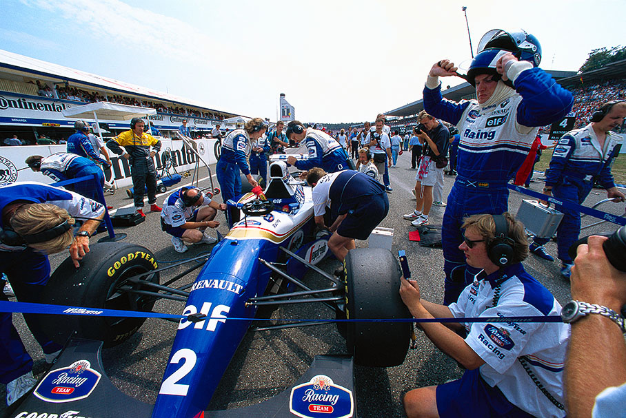 Williams driver David Coulthard prepares for action and squeezes the helmet on