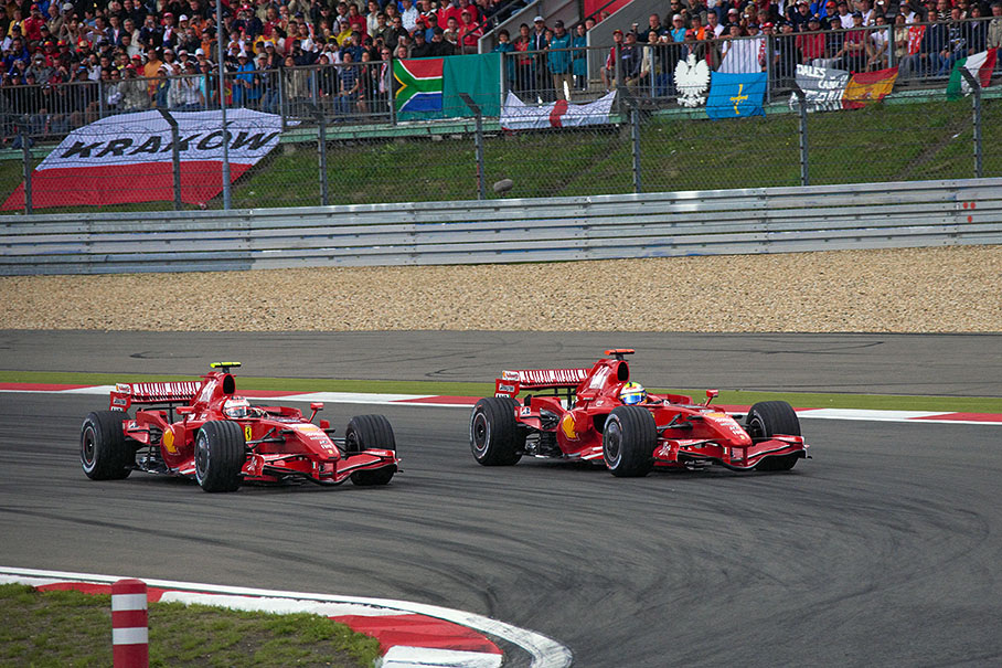 Both leading Ferraris at first corner