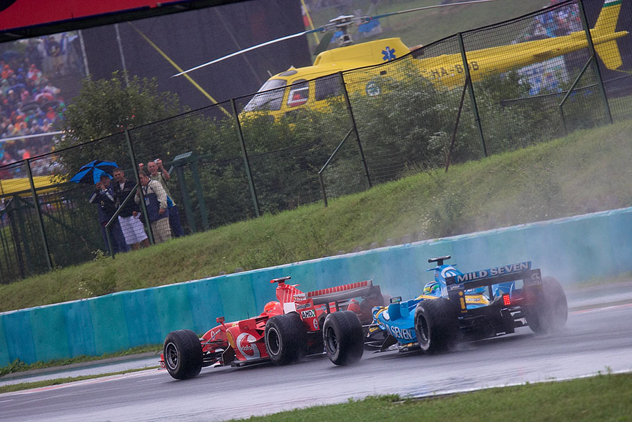 Michael Schumacher with Giancarlo Fisichella in his neck