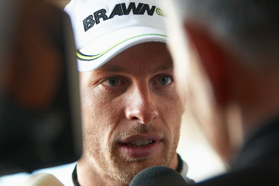 The victorious Jenson Button is being interviewed after the race by Peter Windsor