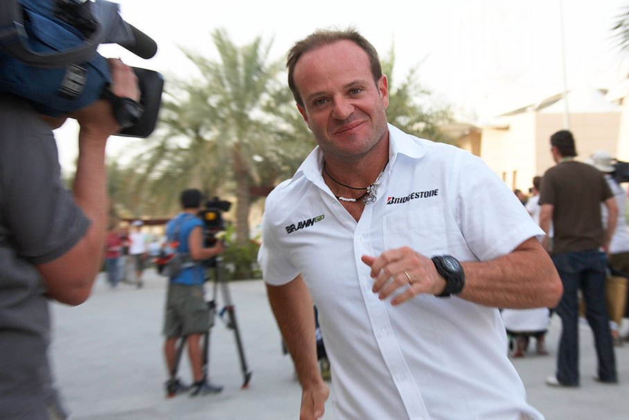 Rubens Barrichello speeds through the paddock