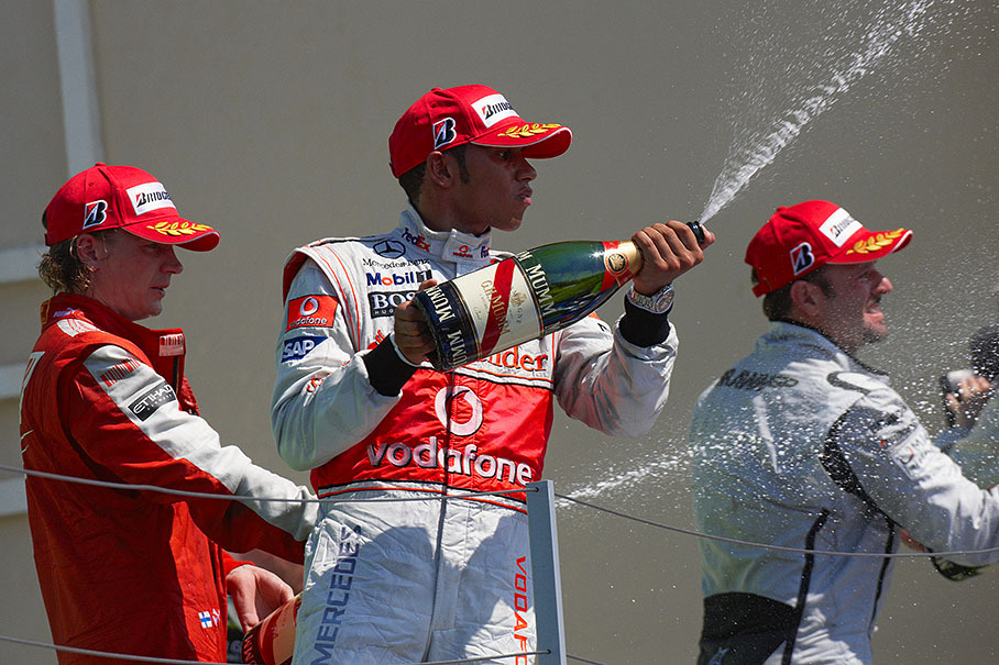 Second placed Lewis Hamilton sprays champagne together with third placed Raikkonen and winner Barrichello