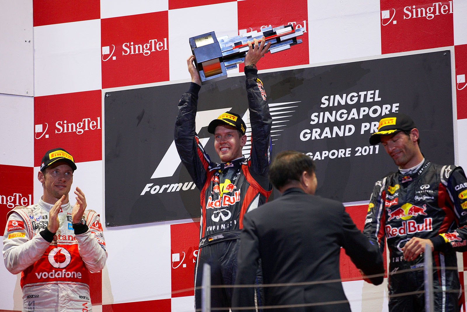 Red Bull Racing's race winner Sebastian Vettel presents his trophy during podium ceremony