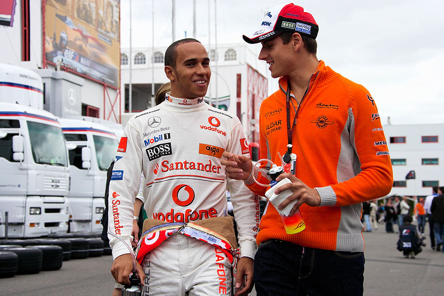 Lewis Hamilton and Adrian Sutil walk through paddock