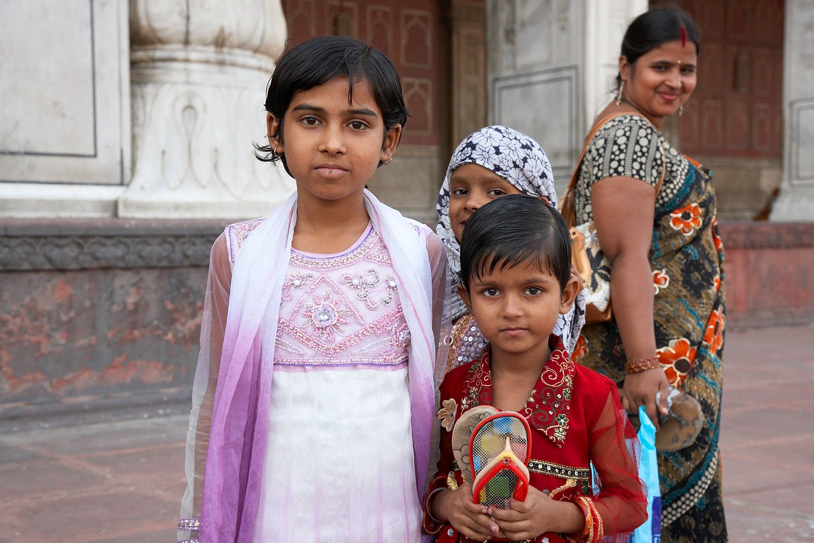 Children play on the square in front of the temple
