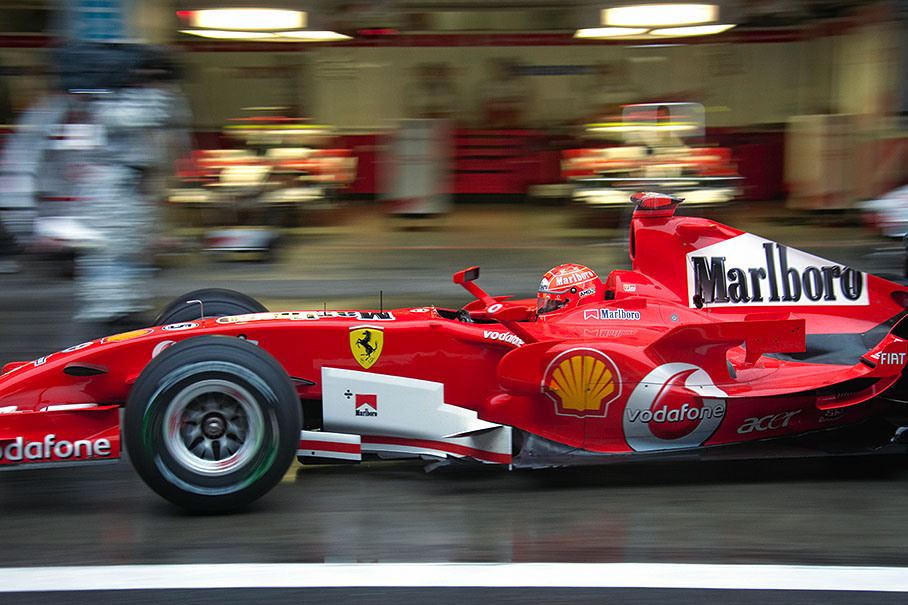 Michael Schumacher rushing through pit lane after his qualifying session pit stop