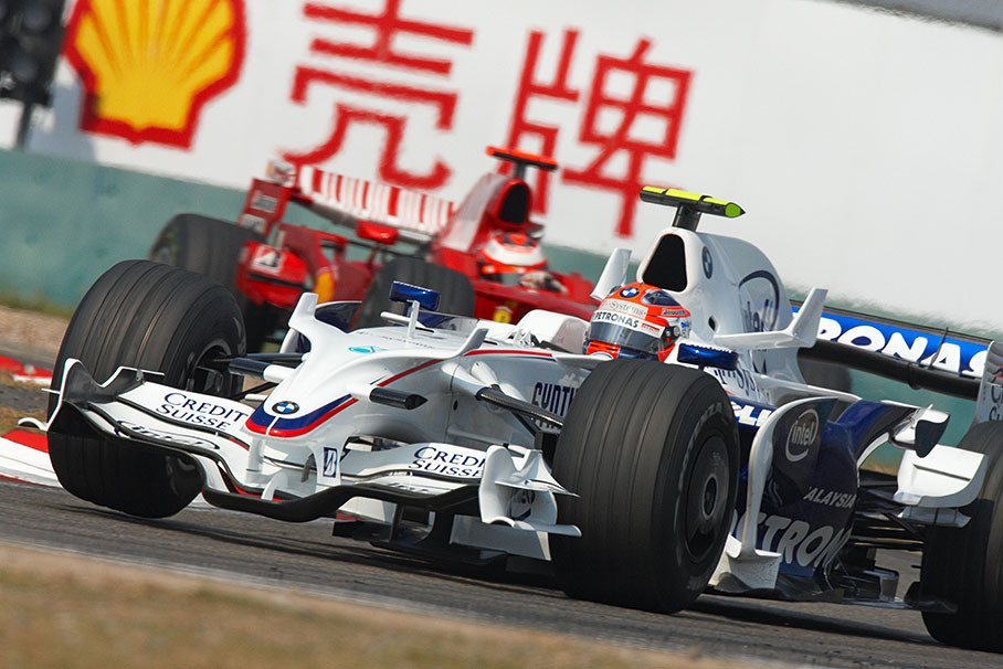 Robert Kubica, BMW Sauber F1, in front of Raikkonen's Ferrari