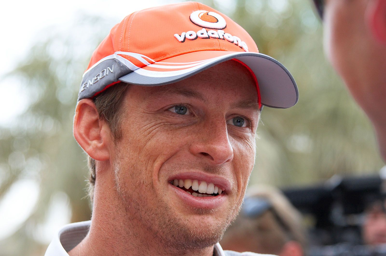 McLaren's Jenson Button speaks with a journalist