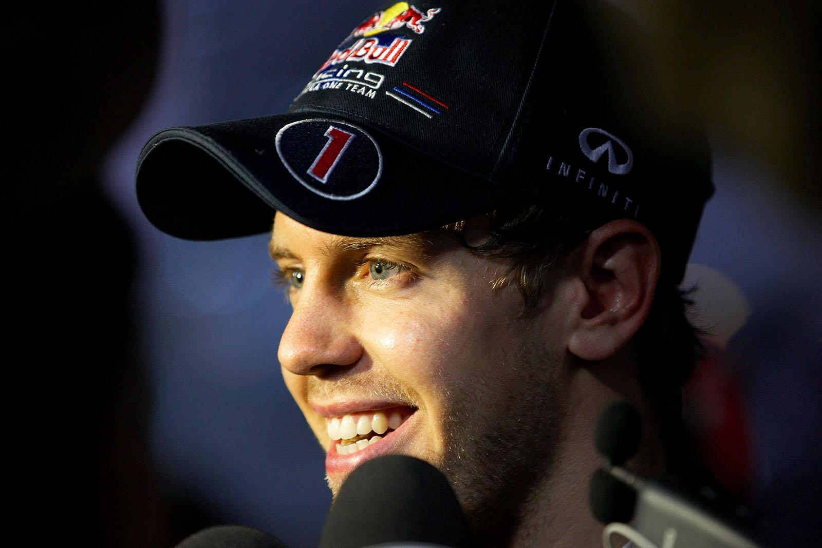 Race winner Sebastian Vettel of Red Bull Racing smiles at the world after winning his 11th race of the season