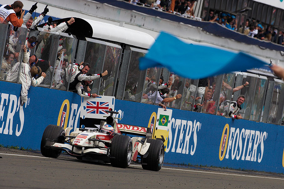 Jenson Button passes his cheering Honda team, winning the Hungarian GP 2006 and scoring his first F1 victory ever