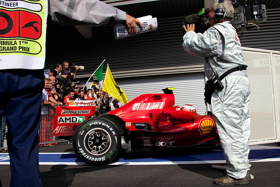 Winner Kimi Raikkonen parks his Ferrari behind parc fermé fencing
