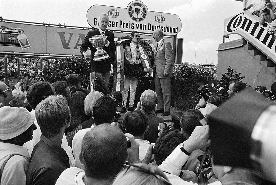 Winner of the German Grand Prix 1969: Jacky Ickx with Duke of Metternich next to him holding the trophy in his hands