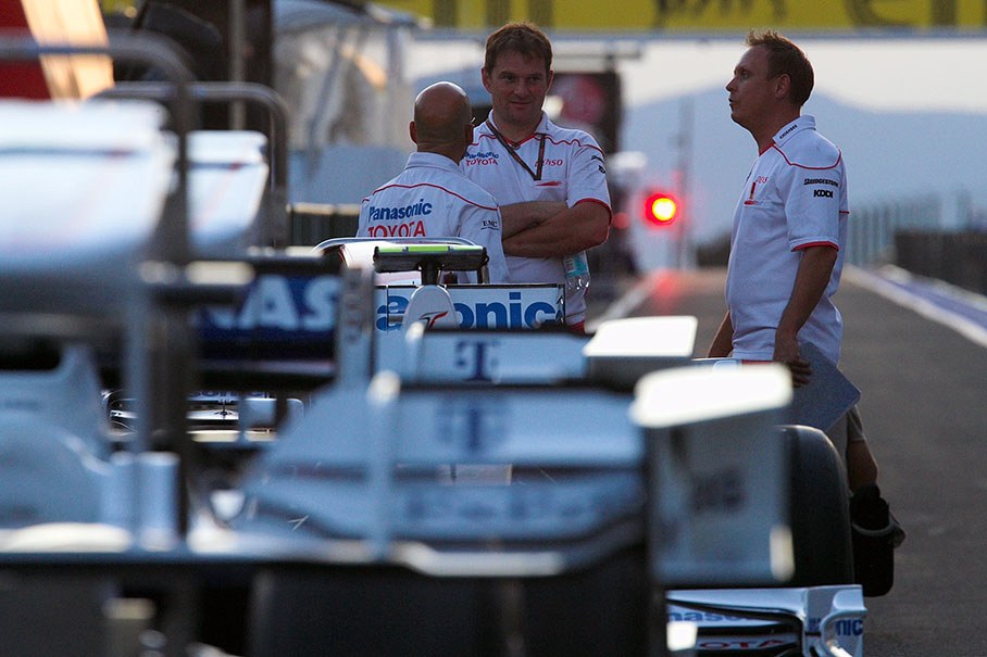 Toyota engineers wait for the FIA matrices in pitlane on Friday evening
