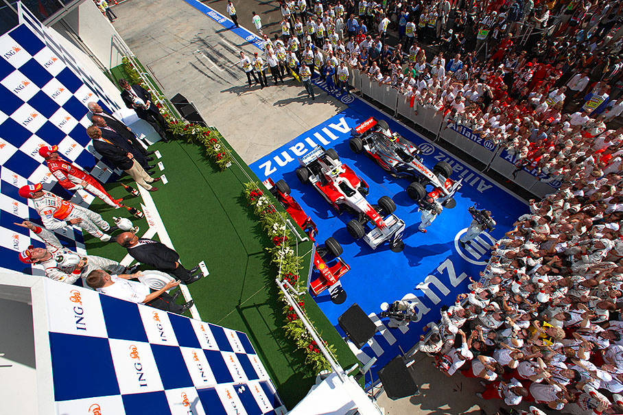 Second placed Timo Glock on his maiden podium points to the sky