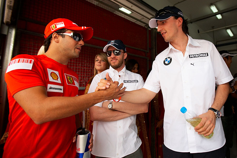 Handshake beween polesetter Kubica and later race winner Massa