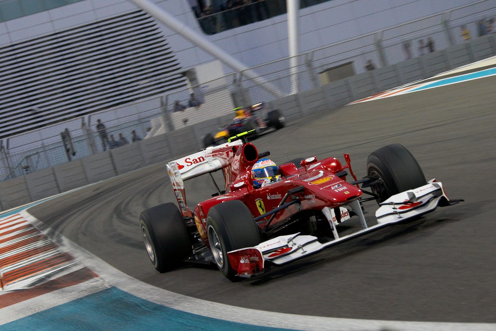 ... followed by a hard pushing Alonso of Ferrari and a pursuing Webber ...