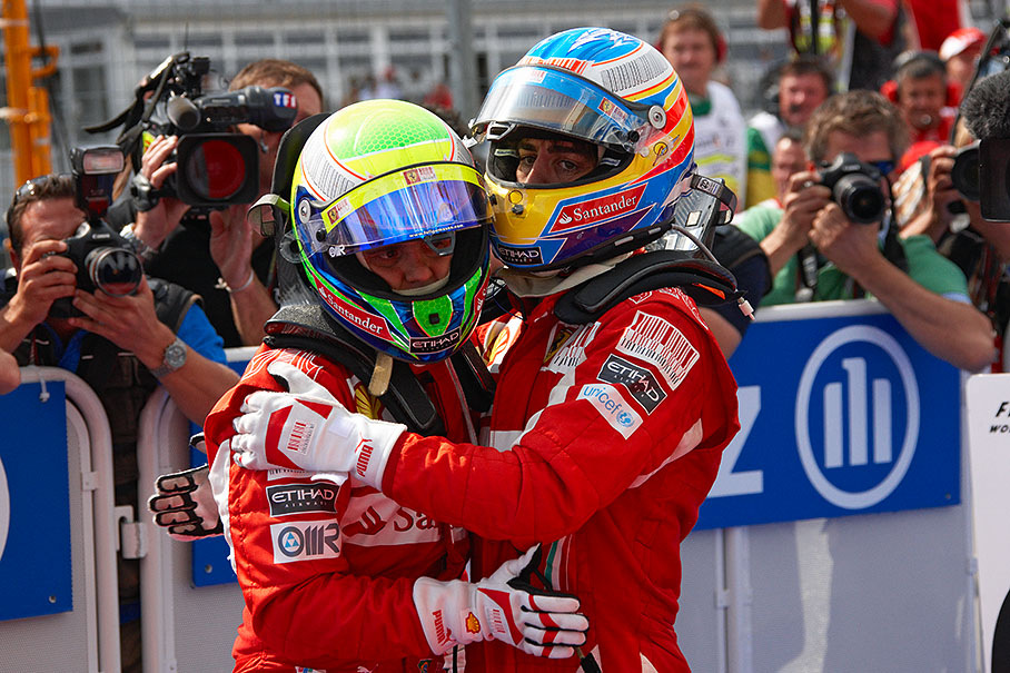 Race winner Alonso and second placed team mate Massa congratulate each other in parc ferme after a controversial Hockenheim win