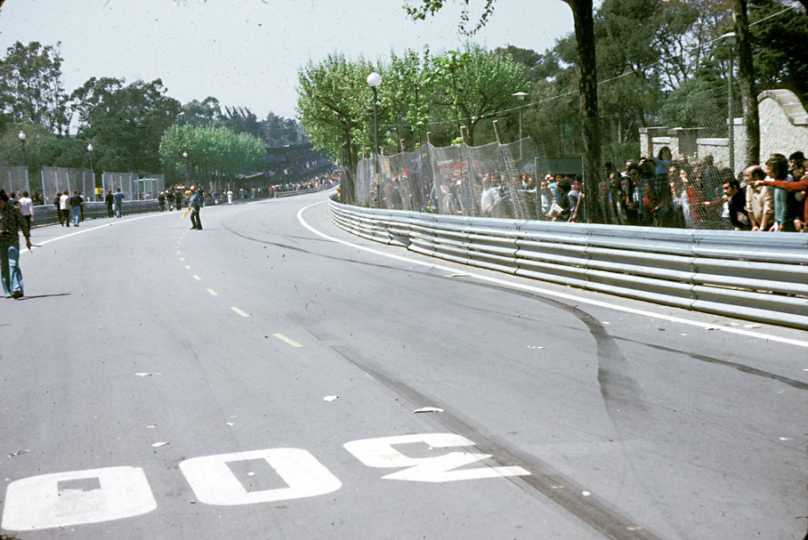 Rubber marks and cracked armco barrier show the path of Rolf Stommelen's tragic accident caused by a rear wing failure. His Hill Cosworth then bounced back accross the track and flew over the barrier, killing five people and seriously injuring Stommelen. This accident marked the end of notorious Montjuich street circuit.