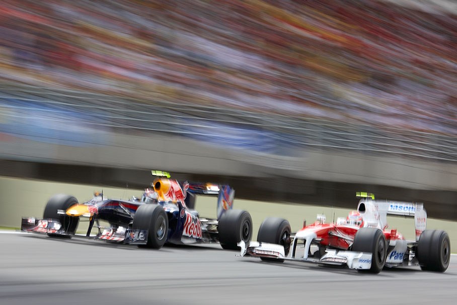 Sebastian Vettel of Red Bull Racing and Toyota's Kamui Kobayashi wheel-to-wheel