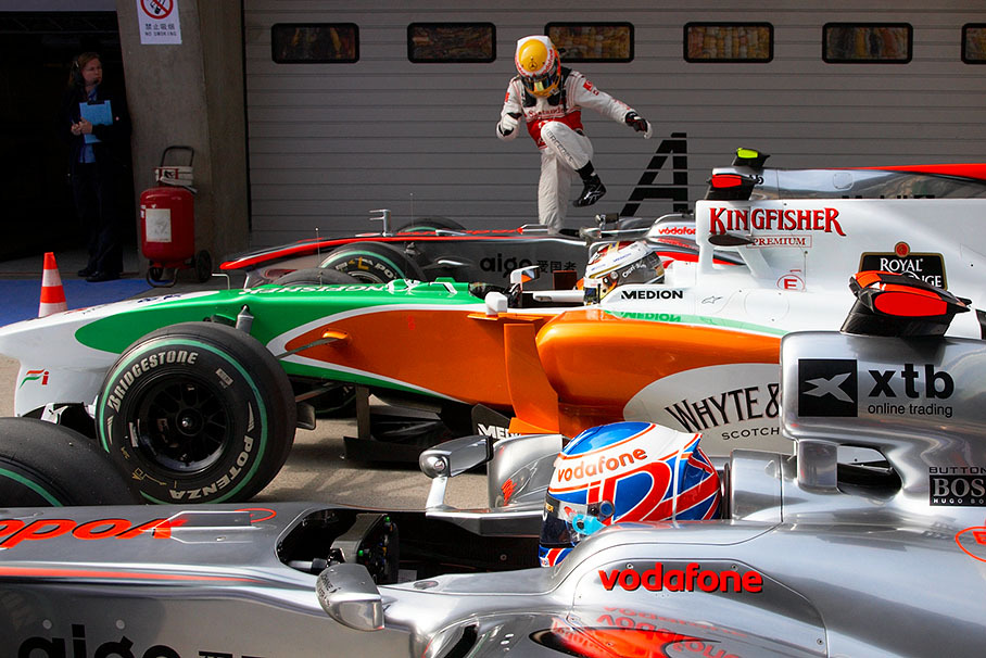 After qualifying, the competitors Button, Sutil and Hamilton stop their cars in parc ferme